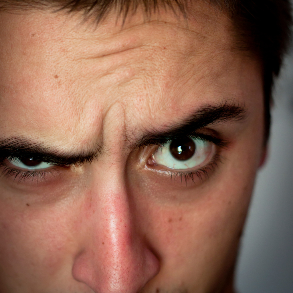 Person with a skeptical expression questioning whether TMS therapy for depression really works.