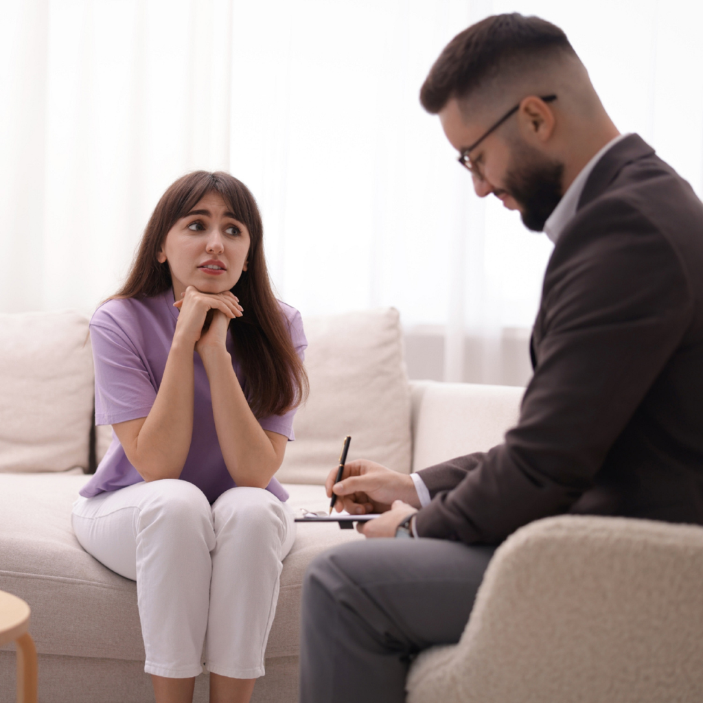 Patient discussing health anxiety symptoms with a mental health professional during a clinical evaluation.