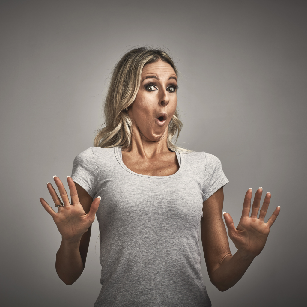 Woman reacting with fear and pulling back, illustrating avoidance behavior in anxiety.