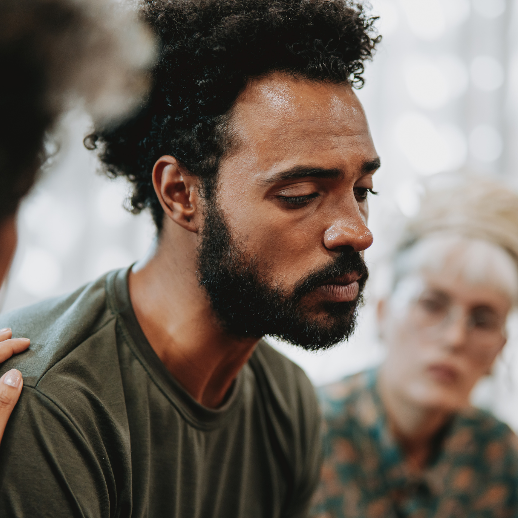 PTSD and Sleep: Why Rest Feels Impossible and What Can Help 2 Person with PTSD receiving emotional support from loved ones during a difficult moment.