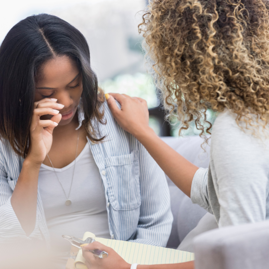 PTSD and Sensory Overload: Why It Happens and How to Manage It 2 Woman receiving support during PTSD therapy session.