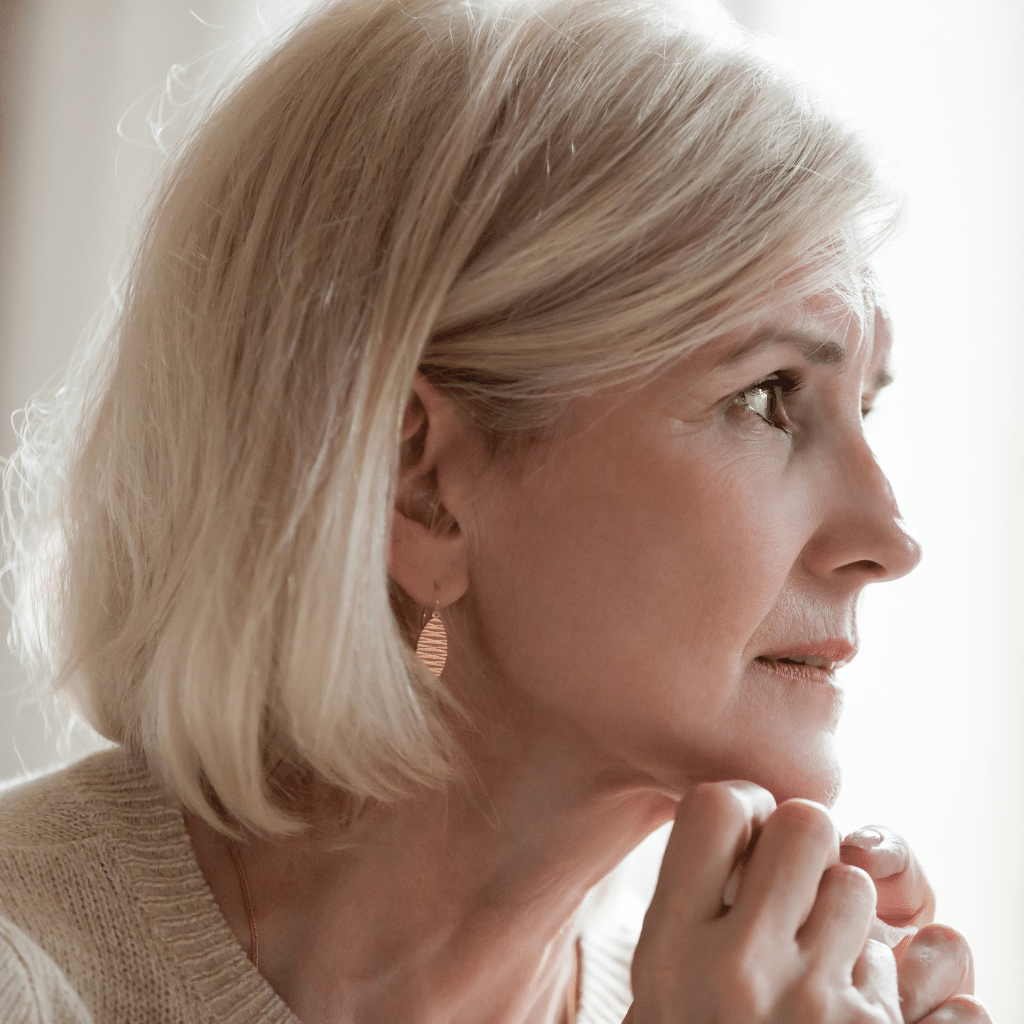 Older woman reflecting on depression after retirement.