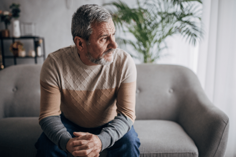 Retired man sitting alone with signs of depression after retirement.