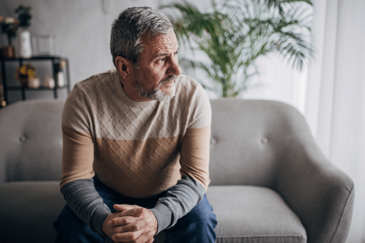 Retired man sitting alone with signs of depression after retirement.
