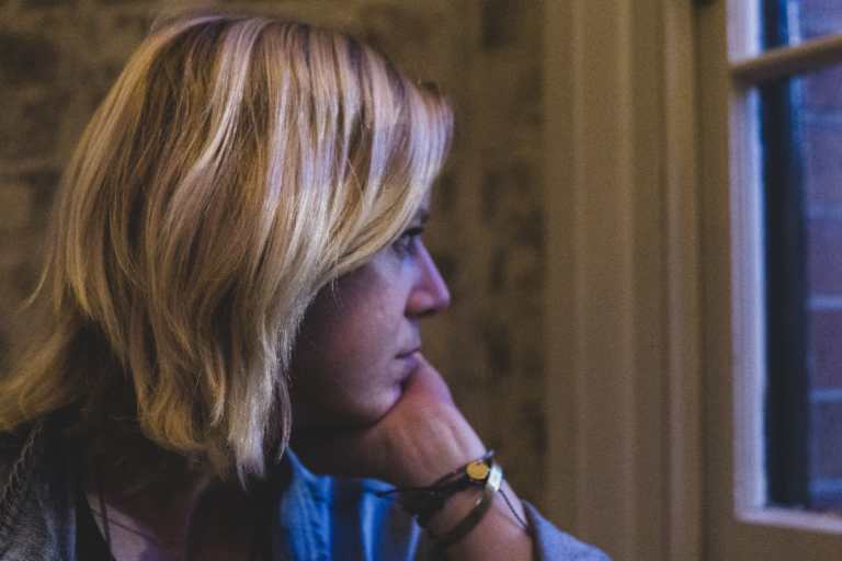 Woman looking emotionally numb and disconnected, reflecting atypical depression symptoms.