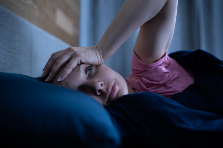 Woman awake at night with sleep maintenance insomnia.