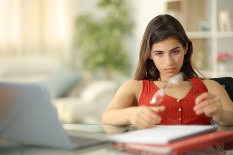 Woman sitting at a desk feeling emotionally numb from depression.