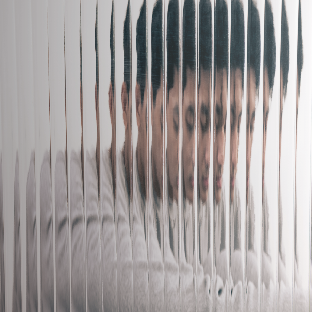 Person seen through blurred glass, reflecting the different ways depression can appear.