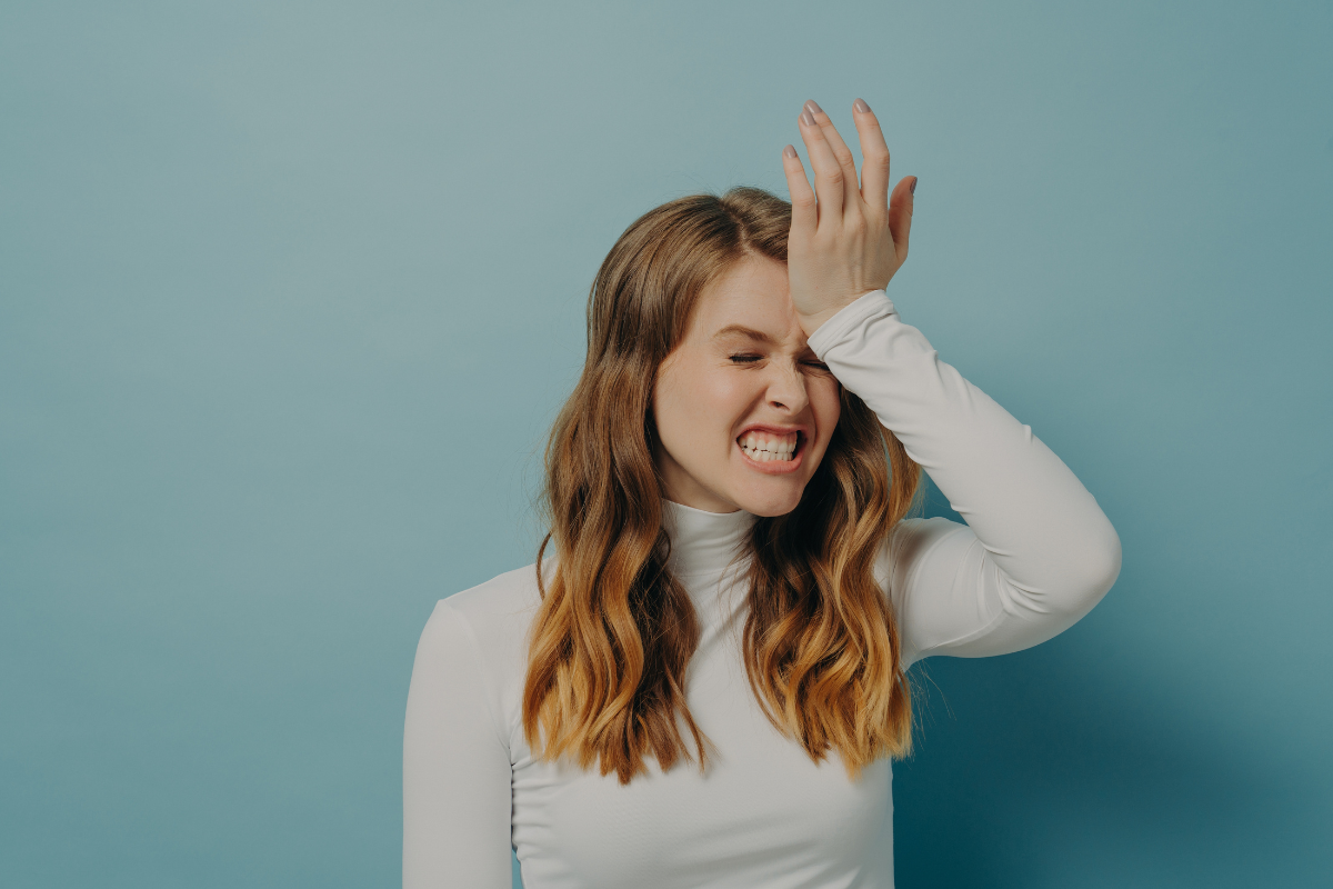 Woman expressing frustration after forgetting something, illustrating ADHD and forgetfulness in daily life.