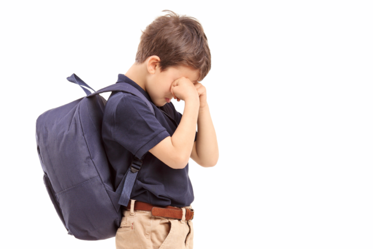 Child with backpack showing distress and anxiety about going to school