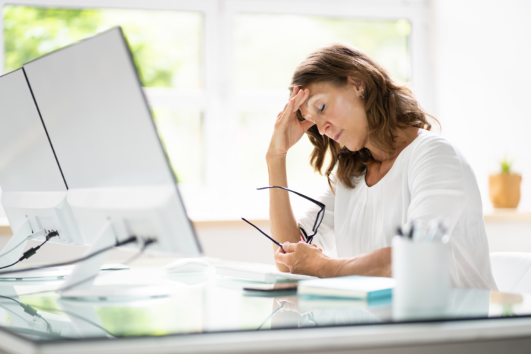 Woman struggling with focus and cognitive symptoms associated with ADHD and perimenopause.