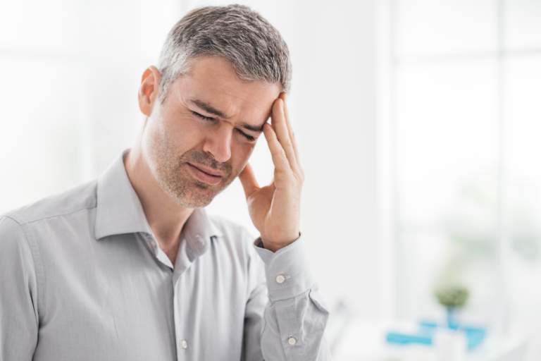 Middle-aged man experiencing stress and emotional exhaustion, representing men's midlife crisis and mental health challenges in midlife.