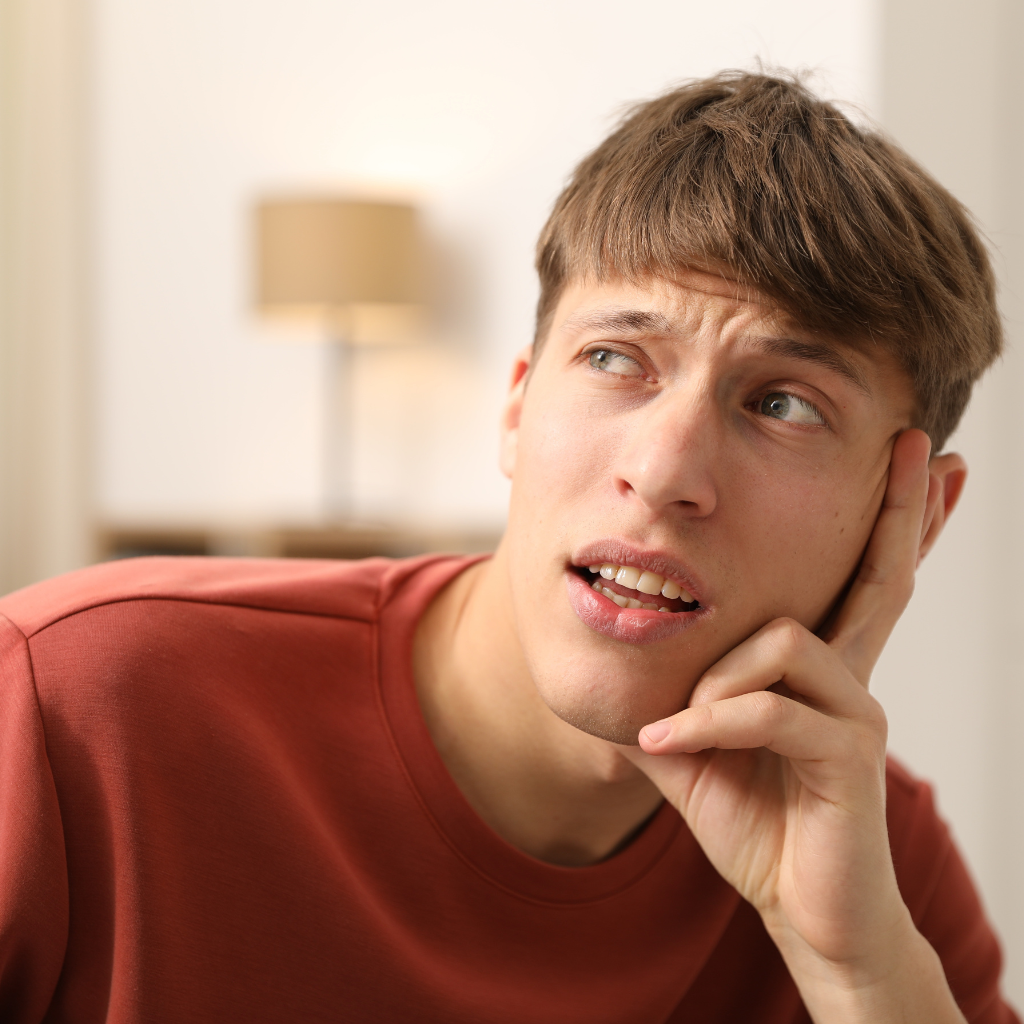 A man with ADHD showing signs of confusion trying to remember something