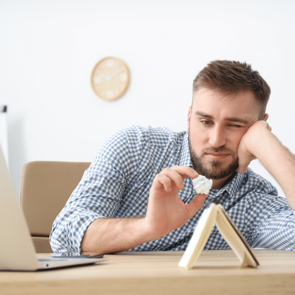 Person experiencing ADHD paralysis while trying to begin a task.