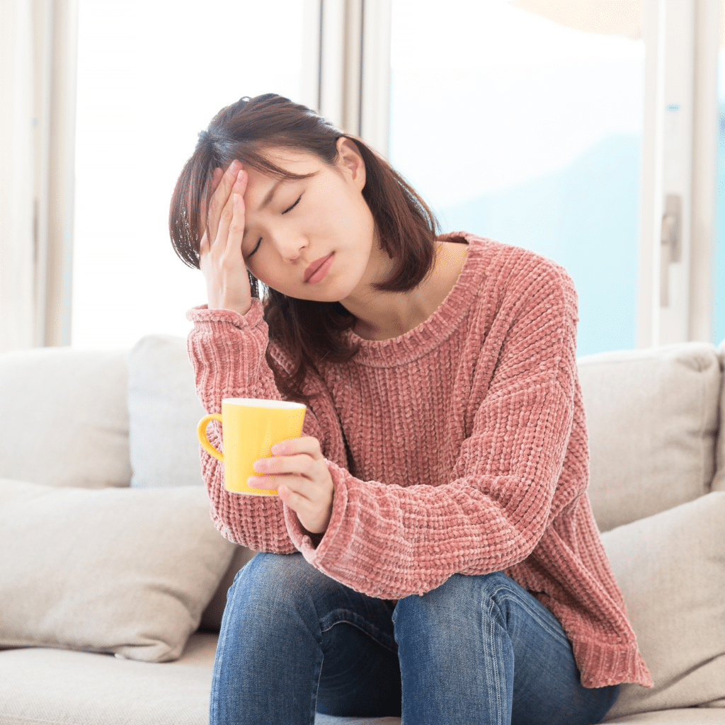 Woman holding her head, showing sign of emotional distress