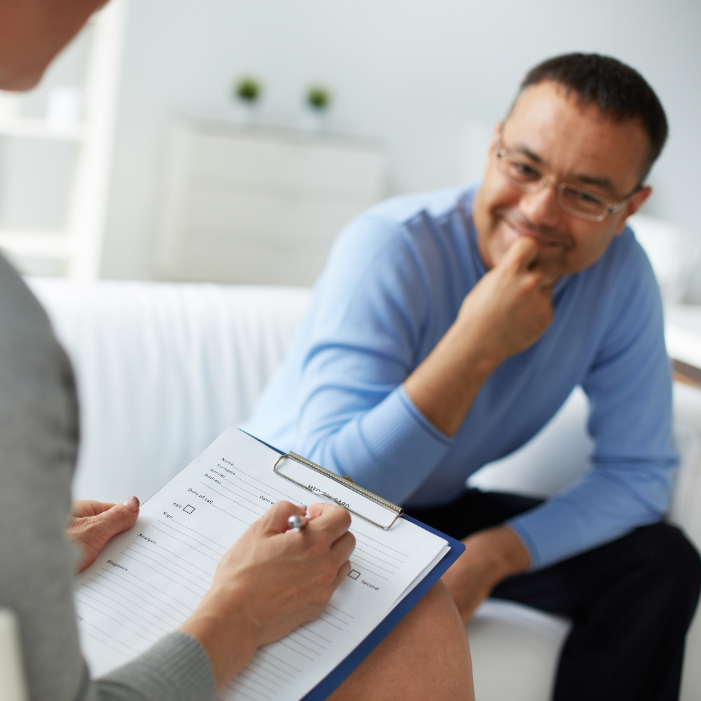 Men's Midlife Crisis: When Everyday Pressure Becomes Something More 2 Man discussing midlife stress and mental health concerns with a therapist during a psychiatric evaluation.