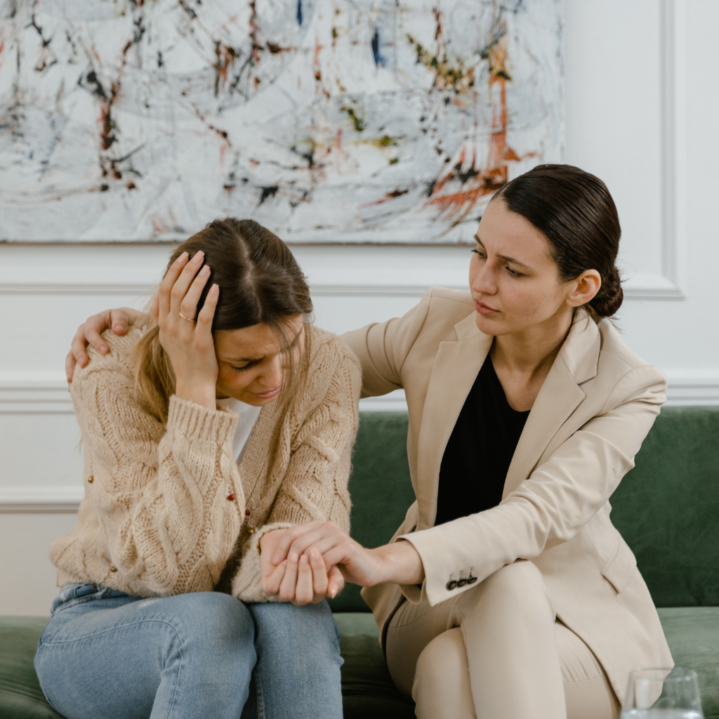 Mental health provider offering support to a distressed woman discussing intrusive thoughts and symptoms of harm OCD.