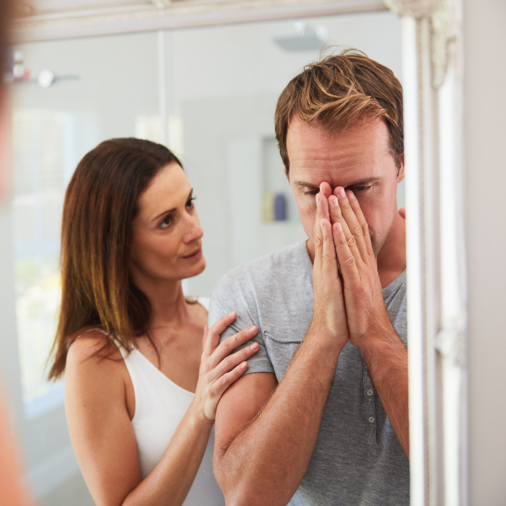 Loved one comforting a distressed person who repeatedly seeks reassurance because of obsessive-compulsive disorder.