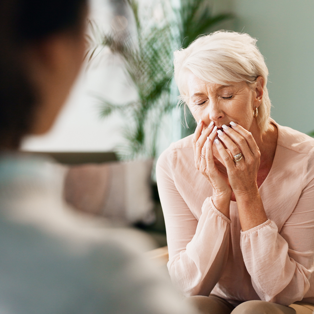 Older woman speaking with a mental health provider about loneliness and depression.