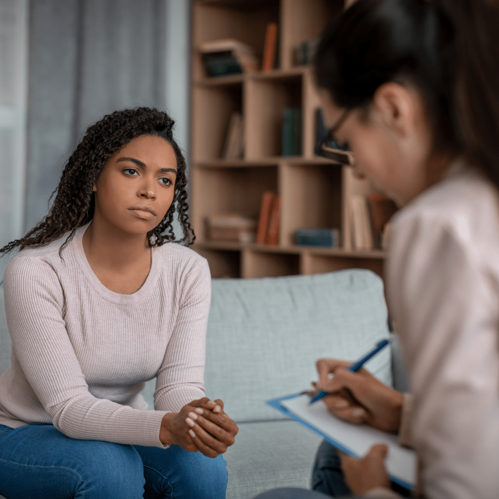 Woman speaking with a mental health provider about treatment options for PMDD symptoms.