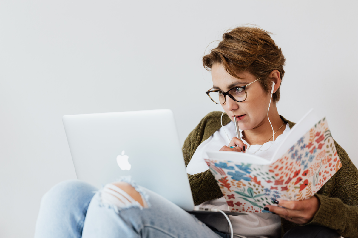 Adult working intensely with a laptop and notebook, reflecting how ADHD hyperfocus can absorb time and attention.