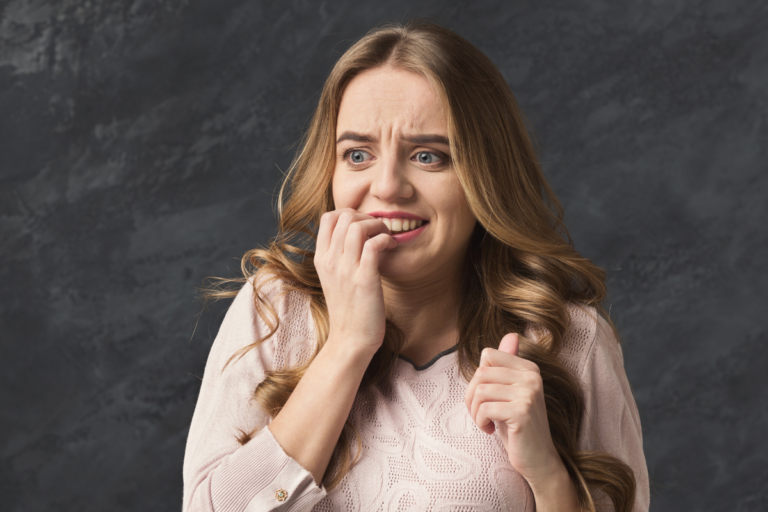 Woman looking tense and worried, showing when everyday worry may start to feel like an anxiety disorder.