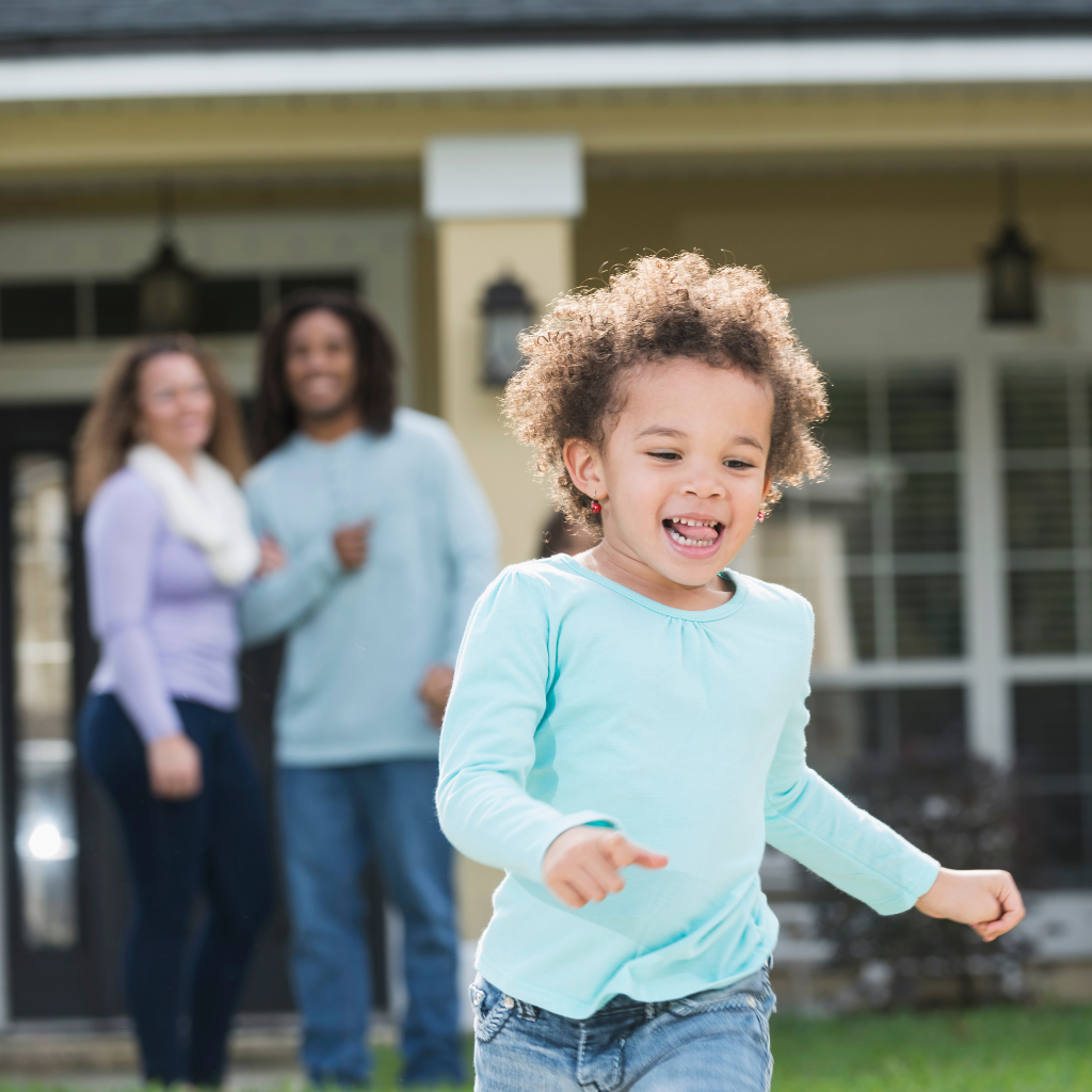 Child running ahead while parents watch nearby, reflecting gradual support that helps anxious children build confidence.