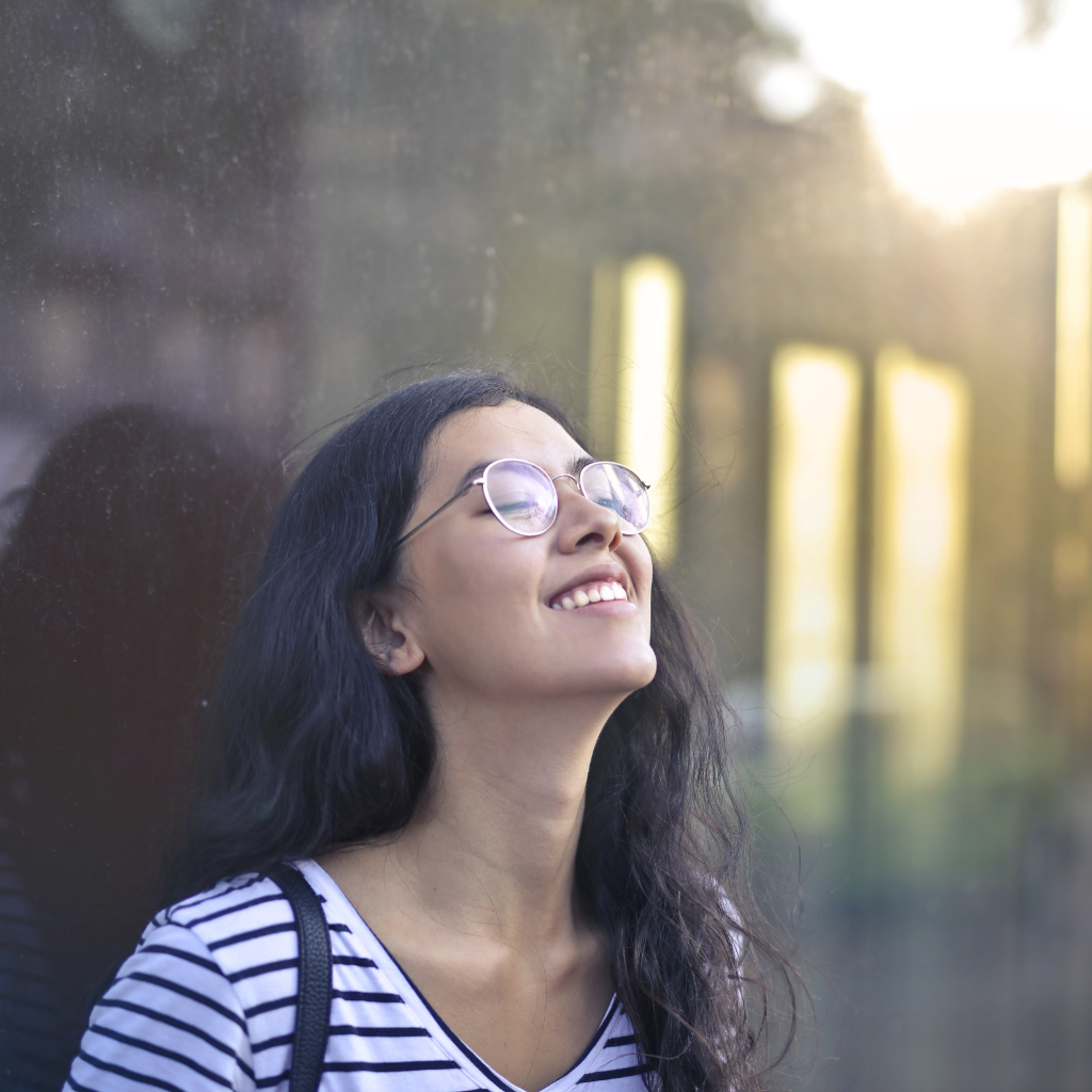 Young adult smiling in soft light, reflecting the small, gradual changes that can show therapy is working.