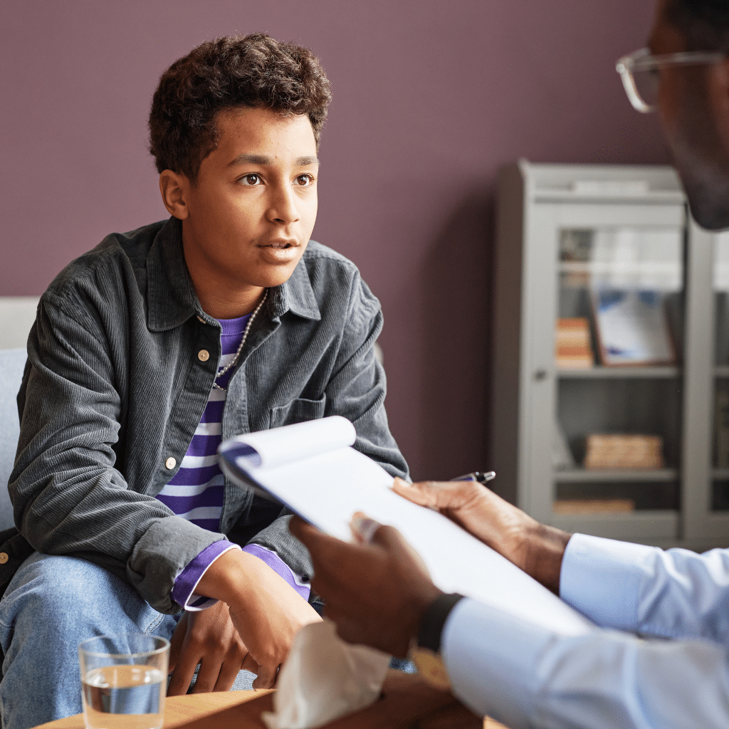 Teen speaking with a psychiatrist about TMS therapy, insurance coverage, and whether treatment may be appropriate.