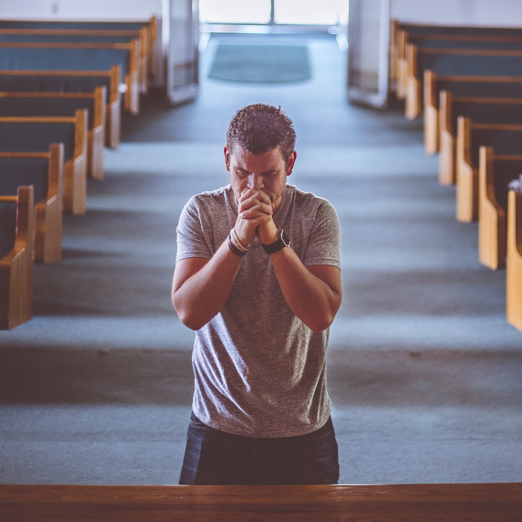 Person praying alone in a church, reflecting how scrupulosity OCD can turn faith and moral doubt into repeated fear.