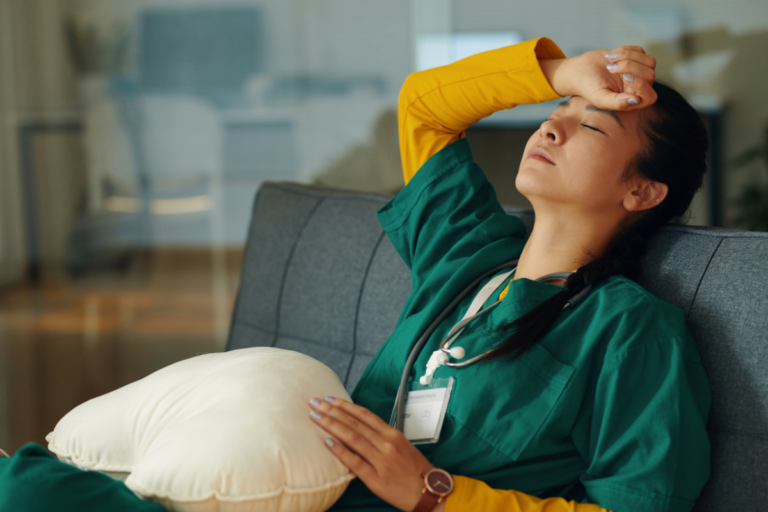 Healthcare worker resting after a difficult shift, illustrating compassion fatigue first responders and caregivers may experience from caring for others.