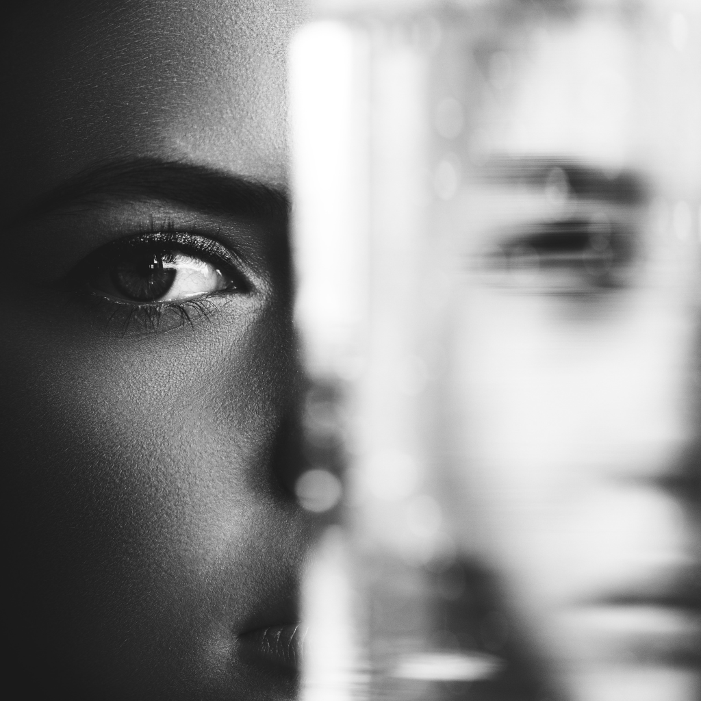Black-and-white close-up of a person’s face, reflecting the inner split of bipolar mixed episode symptoms.