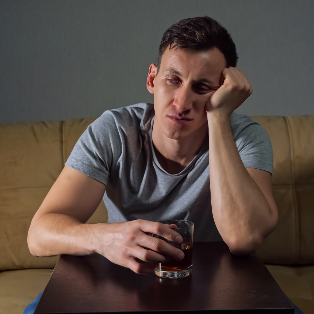 Veteran sitting alone with a drink, reflecting when military reintegration after deployment may need more than time.