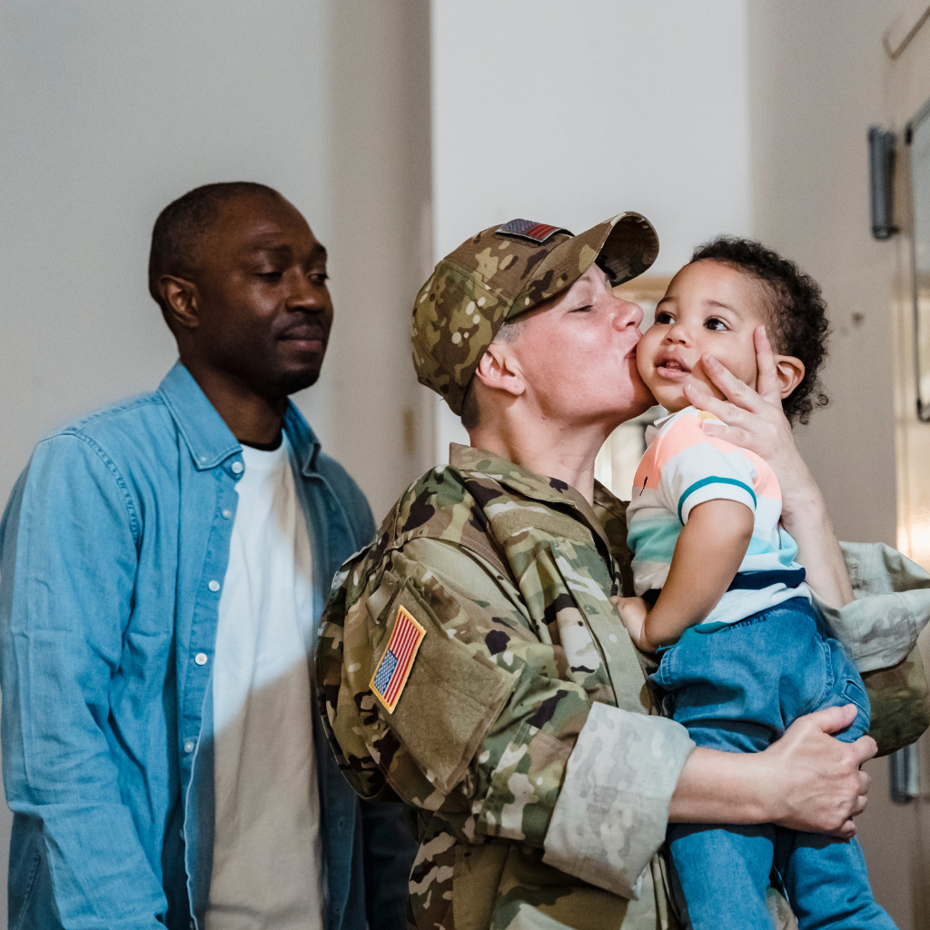 Service member reuniting with family, showing the emotional first step of military reintegration after deployment.