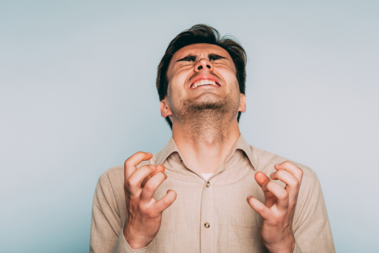 Adult man reacting with visible frustration and overwhelm, reflecting the intense emotional responses associated with ADHD emotional dysregulation.