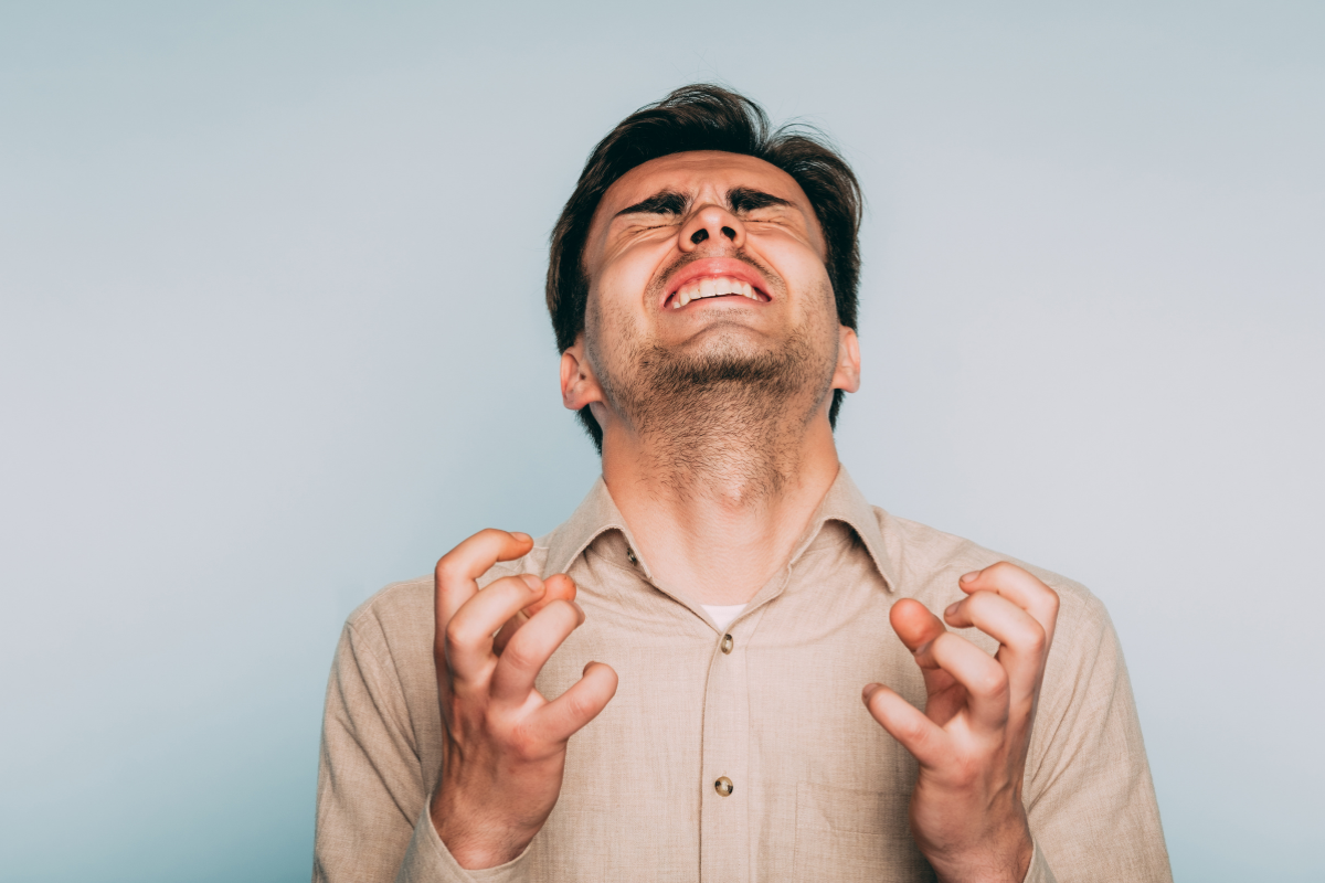 Adult man reacting with visible frustration and overwhelm, reflecting the intense emotional responses associated with ADHD emotional dysregulation.