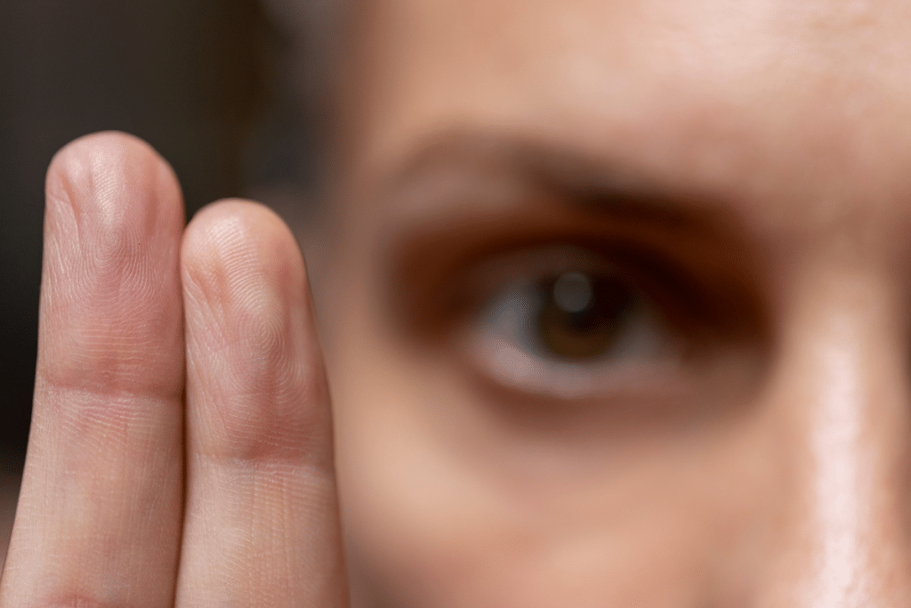 Close-up of a person following a therapist’s fingers with their eyes during EMDR therapy.