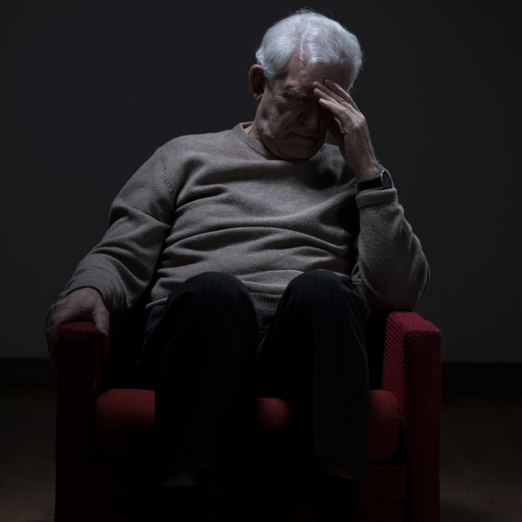 TMS for Older Adults: A Non-Medication Option for Late-Life Depression 1 Older man sitting alone with his head in his hand, appearing tired and depressed.