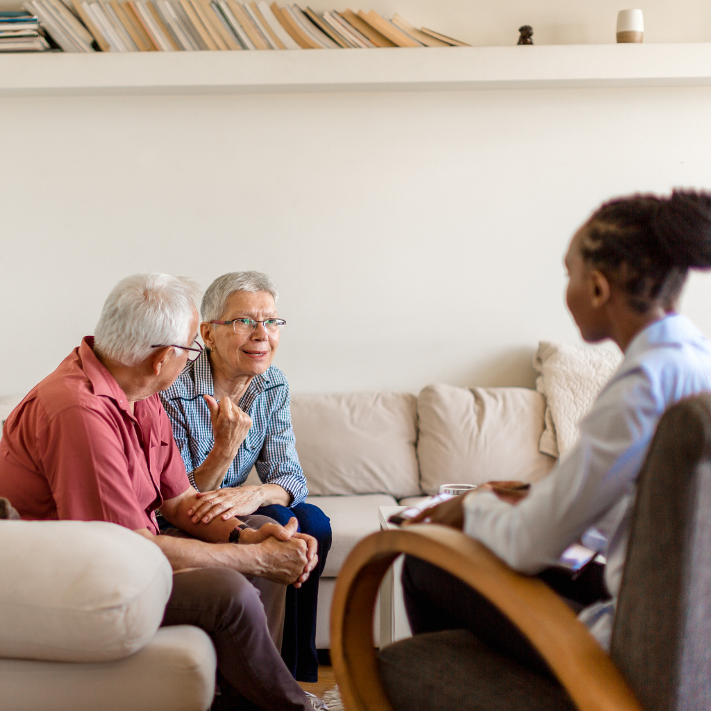 Older couple speaking with a therapist during a counseling session about sleep problems and insomnia treatment.