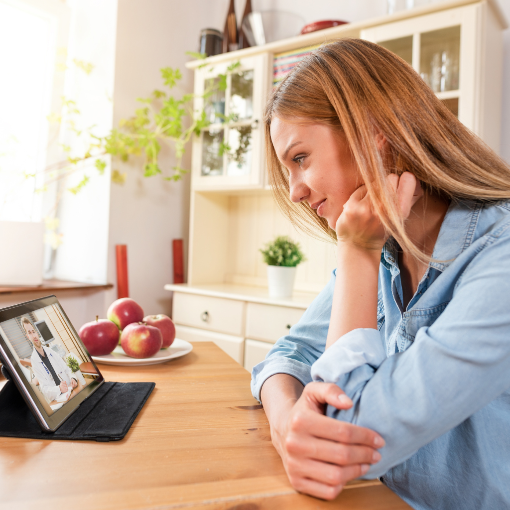 Military spouse speaking with a mental health provider through a telehealth appointment from home.