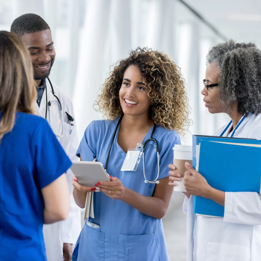 Measurement-Based Care at Animo Sano: What Our Data Shows 2 Healthcare professionals reviewing patient information on a tablet while discussing treatment and coordinated care.