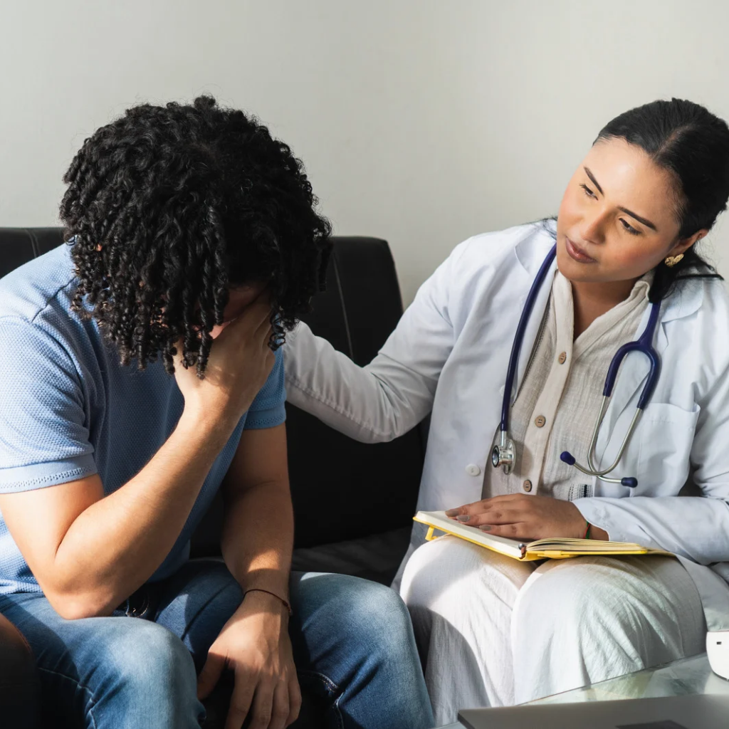 CPTSD Anger and Rage: Why Small Things Set You Off 2 Distressed patient speaking with a mental health provider during a supportive treatment session.